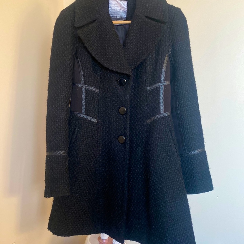 Black wool coat with leather trims. Very good condition.